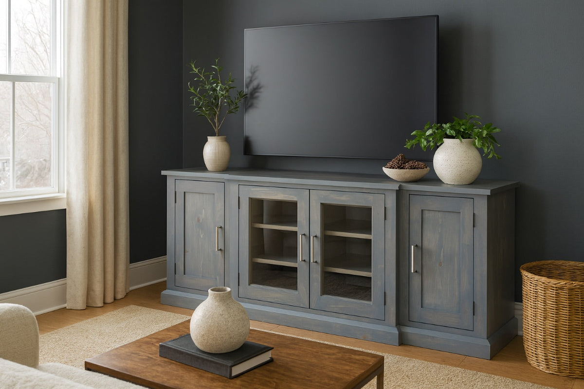 Gray entertainment console with TV and decorative items in a living room.