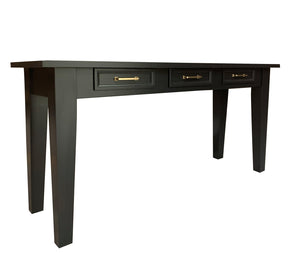 Black console table with gold hardware and three drawers on a white background